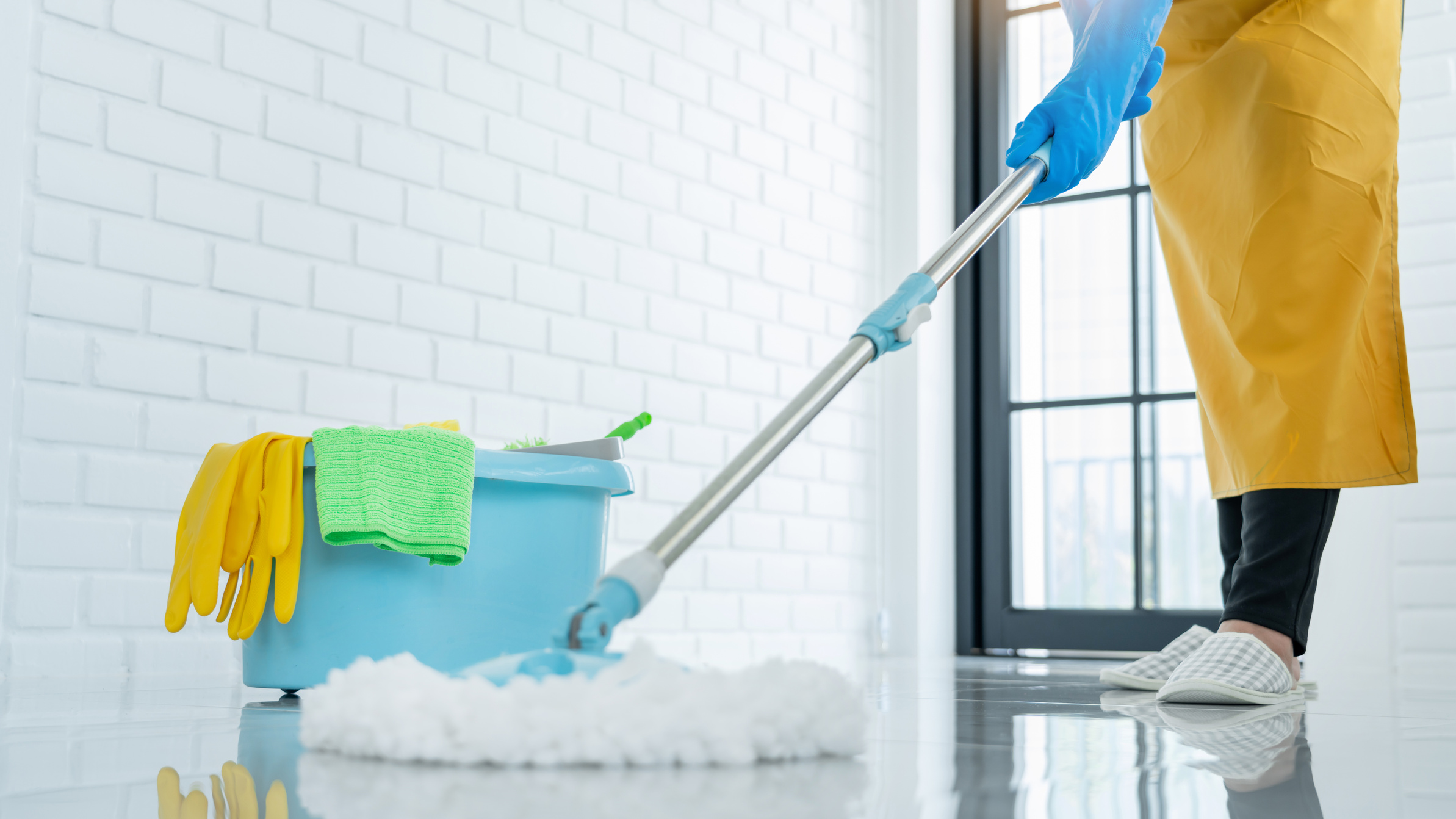 Woman Housekeeper with Mop and Bucket with Cleaning Agents